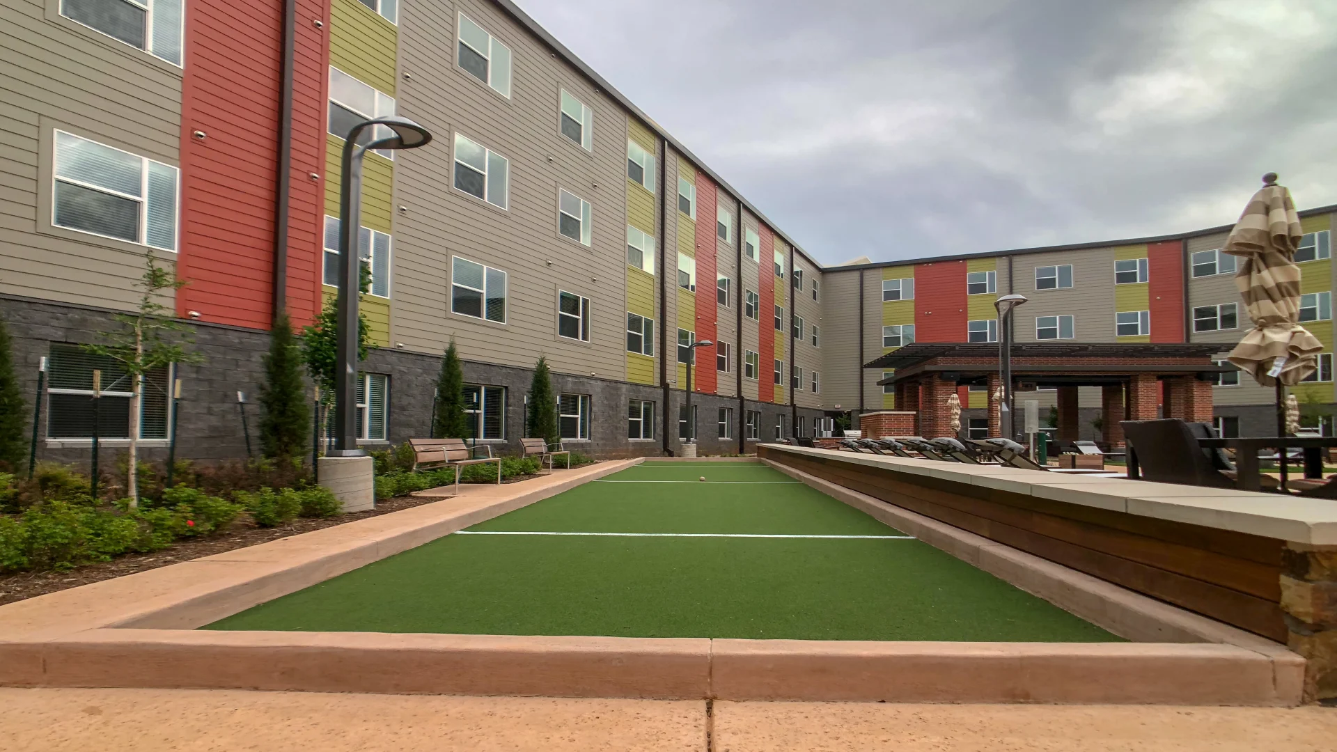 a small artificial turf area in front of a building at The Terra at University North Park