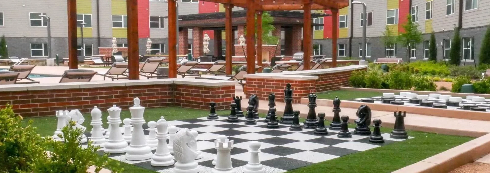 a chess board in front of a courtyard with a patio at The Terra at University North Park