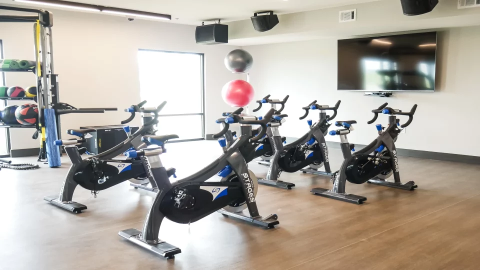a gym room with exercise bikes and treads at The Terra at University North Park