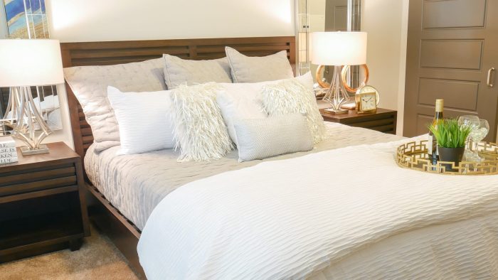 a bedroom with a white bed and two nightstands at The Terra at University North Park