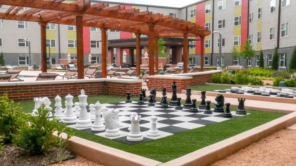 a chess board in front of a courtyard with a patio at The Terra at University North Park